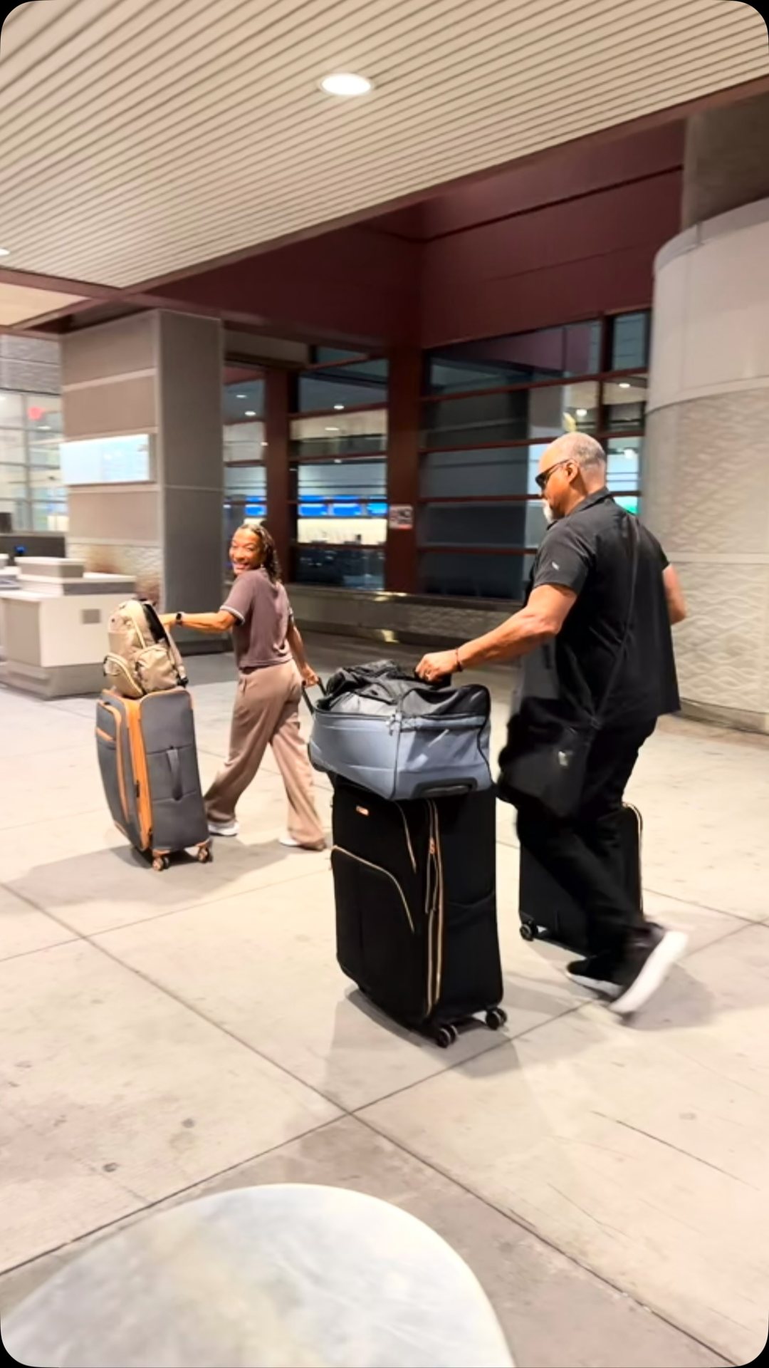 Rafael and Catherine with their suitcases at the airport, Costa Rica bound